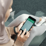 women checking fitness progress on phone